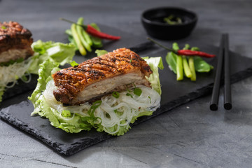 Oriental Roast Pork Belly with crispy skin with greens and noodles