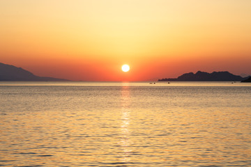 Fototapeta na wymiar Sunset from Loutraki beach, Gulf of Corinth, Greece