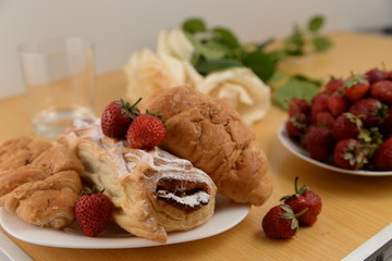 Delicious breakfast with fresh pastry and strawberries 