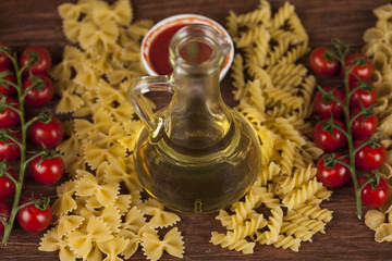 Dry pasta with ingredients on a old wood