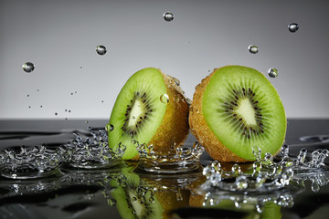 Kiwi with water drops on grey background