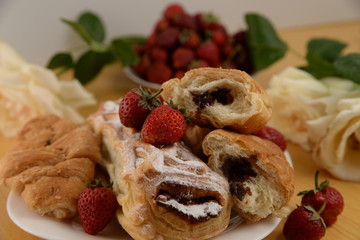 Delicious breakfast with fresh pastry and strawberries 