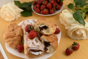 Delicious breakfast with fresh pastry and strawberries 
