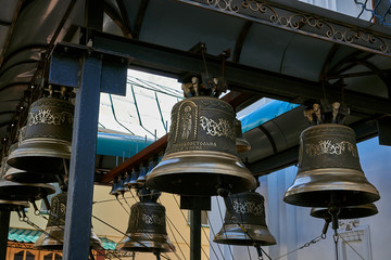 Obraz premium Bells with a beautiful ornament. Bells hung on a metal beam