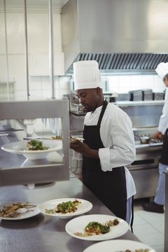Male chef keeping appetizer plate ready on the order station