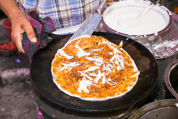 Fried pizza with oil in the street in Yangon, Myanmar.