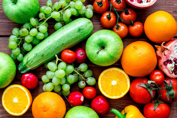 fresh vegetables and fruits for fitness dinner on wooden background top view