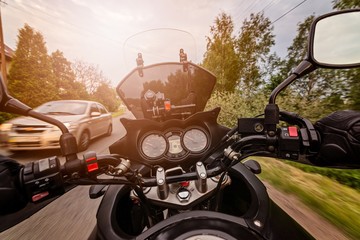 Man driving his motorcycle on asphalt country road