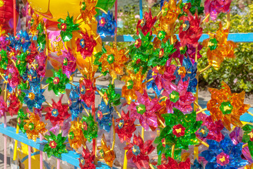 Fototapeta na wymiar a lot of beautiful colored pinwheels, rotating toys, background, focus selection