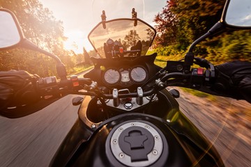 Man driving his motorcycle on asphalt country road
