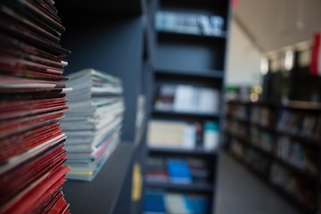 Stack of books on shelf in library