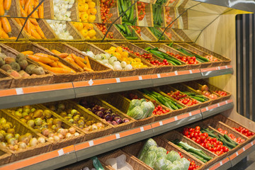 Supermarket shelves and aisles full of vegetables
