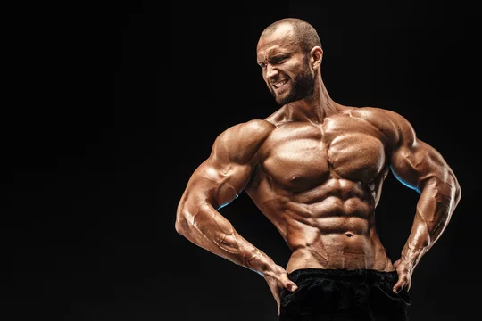Strong bald bodybuilder with six pack. Strong bodybuilder man with perfect  abs, shoulders,biceps, triceps and chest, personal fitness trainer flexing  his muscles Stock Photo | Adobe Stock