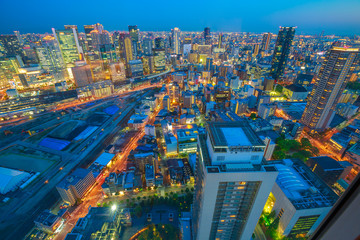 Aerial view of Osaka City Central Business downtown at twilight. Osaka Skyline from Floating Garden Observatory Umeda Sky Building in Kita Ward, Japan.