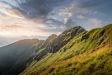 Beautiful alpine mountain landscape with dark clouds in the evening light