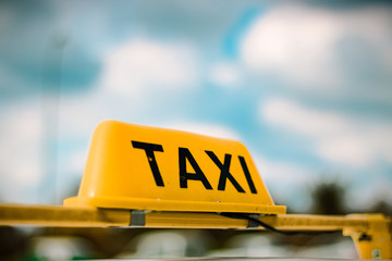 A taxi sign with blurred background