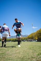 Low angle view of men playing rugby