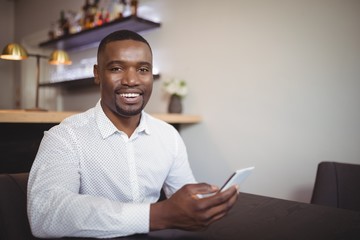 Man using mobile phone in restaurant