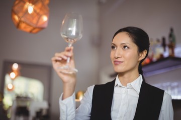 Waitress looking at empty wine glass