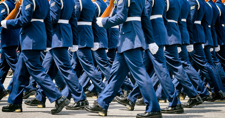US soldiers in blue dress uniforms march in a Memorial Day parade. Close up detail. Location: Washington DC