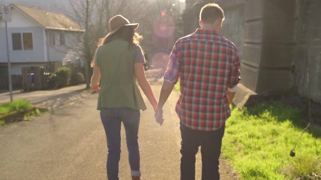 Cute Couple Hold Hands And Walk Together On A Beautiful Sunny Day