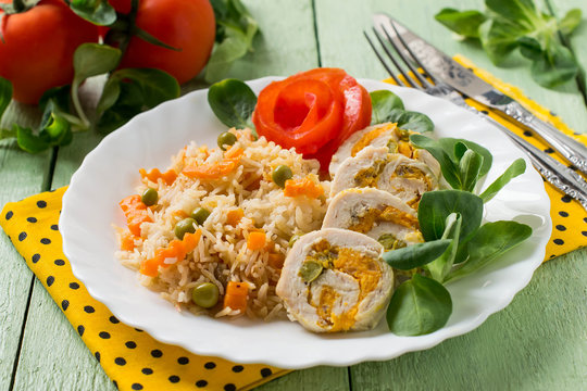 Stuffed chicken roll with spicy rice and vegetables