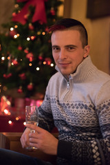 Happy young man with a glass of champagne