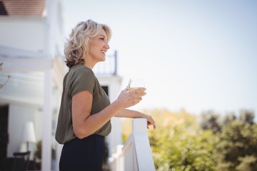 Smiling mature woman holding a glass of juice