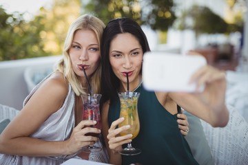 Womens taking selfie on mobile phone