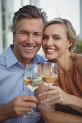 Couple toasting glasses of wine in restaurant
