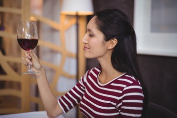 Woman having a glass of red wine