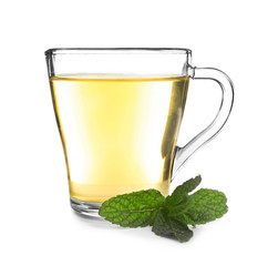 Cup of tea with mint leaves on white background
