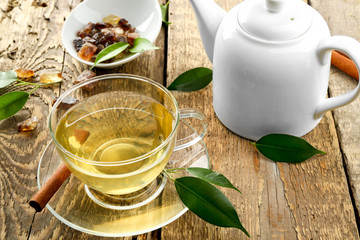 Teapot and cup of tea on wooden table