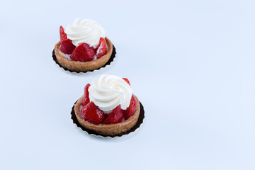  Two delicious strawberry tarts with chantilly cream - tartellete - isolated in white background