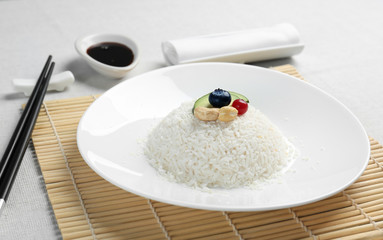 White plate with tasty coconut rice on table