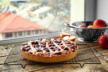 Delicious cherry pie on windowsill