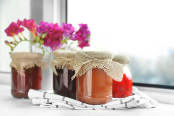 Jars with jam on windowsill
