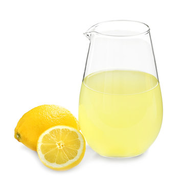 Delicious lemon juice in pitcher on white background