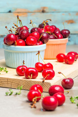 Red ripe cherries in ceramic bowls