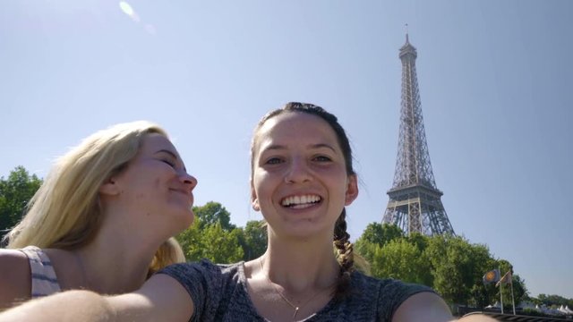 Happy Young Women Pose For Fun Selfies On A Tour Boat Floating Down The River Seine In Paris, Eiffel Tower Prominent In Background