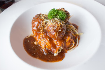 Spaghetti with porkballs in tomato sauce. Parmesan and vegetables.  Italian style.