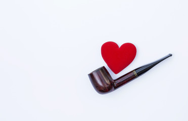 Antique wooden pipe with red heart on white background, Father's day concept background