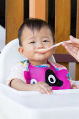 Asian cute baby eating food.