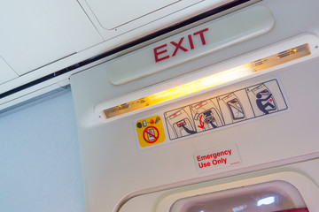 Exit sign and symbols in an aircraft cabin