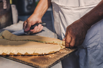 A man is cooking a pie in the market of chinatown, Malaysia. Street food.