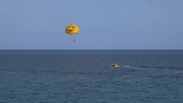 parasailing by boat at Mediterranean sea in daytime, sunny weather
