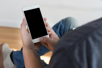 Cropped shot of man's hands holding smart phone with blank copy space  white screen vintage tone copy space