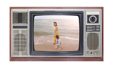Retro television on white background with image of mother and child on the beach on screen.