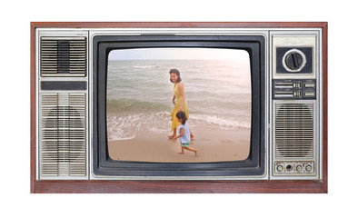 Retro television on white background with image of mother and child on the beach on screen. © zilvergolf