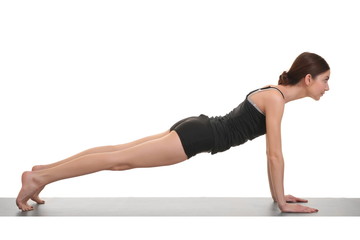 woman doing yoga exercises on yoga mat